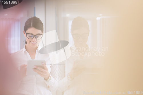 Image of Business Woman Using Digital Tablet in front of startup Office