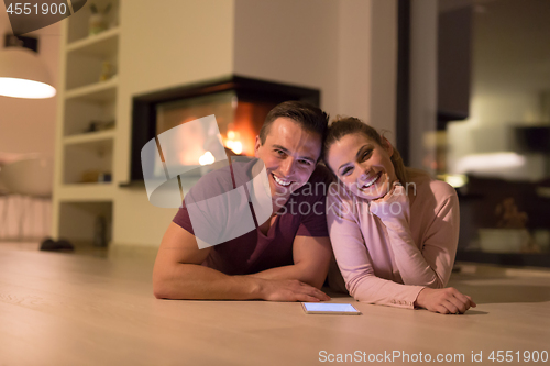 Image of Young Couple using digital tablet on cold winter night