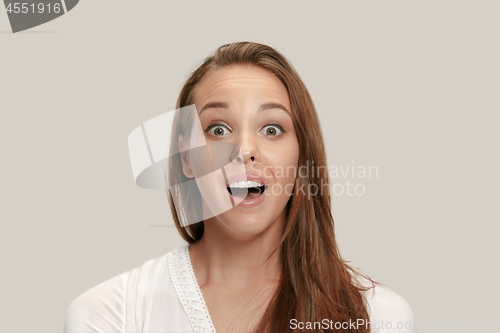 Image of Beautiful woman looking suprised isolated on white