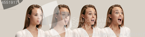 Image of Beautiful woman looking suprised isolated on gray