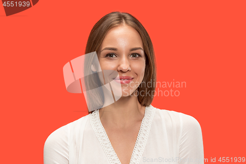 Image of The happy business woman standing and smiling against red background.