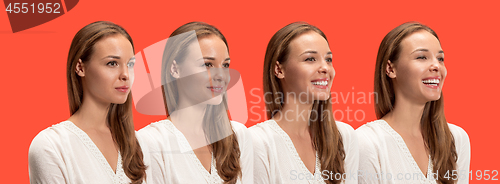 Image of The happy business woman standing and smiling against red background.