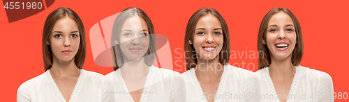 Image of The happy business woman standing and smiling against red background.