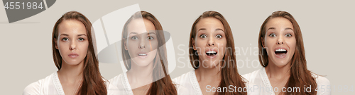 Image of Beautiful woman looking suprised isolated on gray