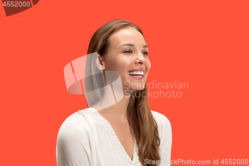 Image of The happy business woman standing and smiling against red background.