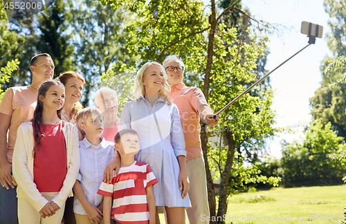 Image of happy family taking selfie in summer garden