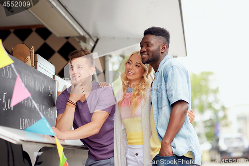 Image of happy customers or friends at food truck