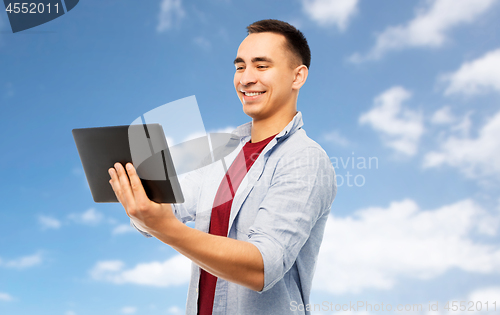 Image of happy young man with tablet computer