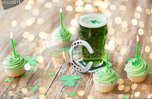 Image of glass of beer, cupcakes, horseshoe and gold coins