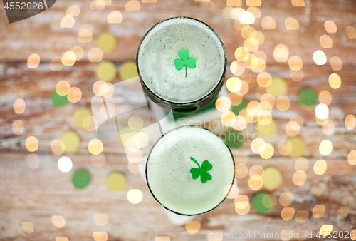 Image of glasses of green beer with shamrock from top