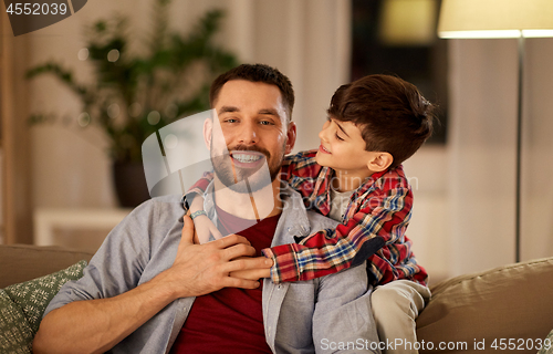 Image of portrait of happy father and little son at home