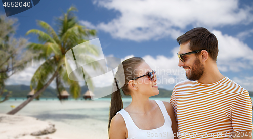 Image of happy couple in sunglasses outdoors in summer