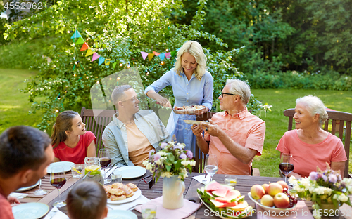 Image of happy family having dinner or summer garden party