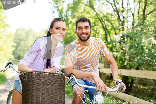 Image of happy couple with bicycles at summer park