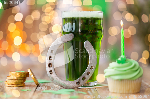 Image of glass of beer, cupcake, horseshoe and gold coins