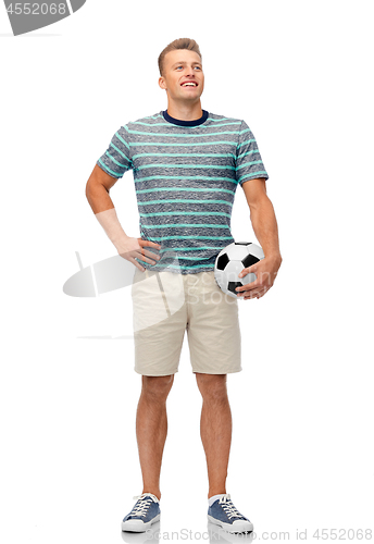 Image of smiling young man with soccer ball