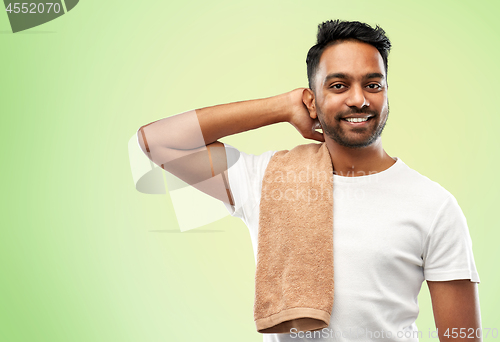 Image of smiling indian man with towel over green 