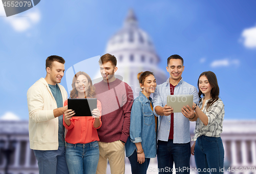 Image of friends with tablet pc over capitol building