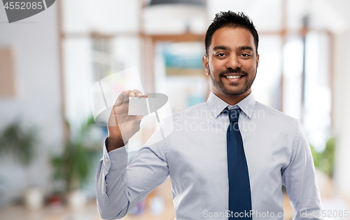 Image of indian businessman with business card over office