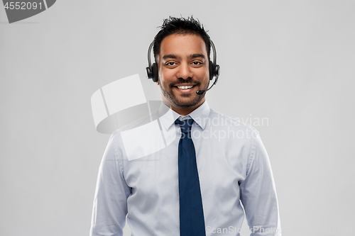 Image of indian businessman or helpline operator in headset