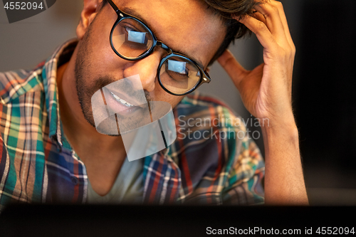 Image of close up of creative man working at night office