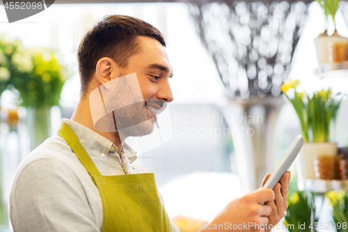 Image of man with tablet pc computer at flower shop