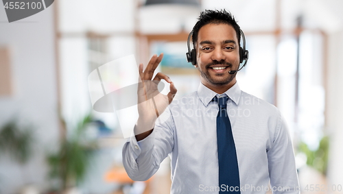 Image of businessman or helpline operator showing ok sign