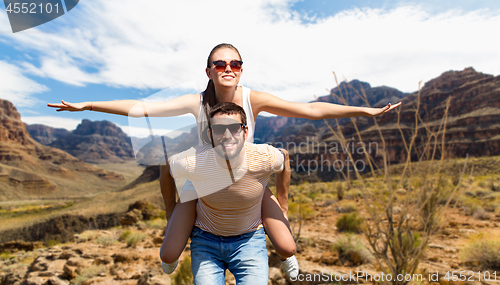 Image of couple having fun in summer over grand canyon