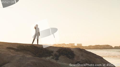 Image of Woman over the cliff