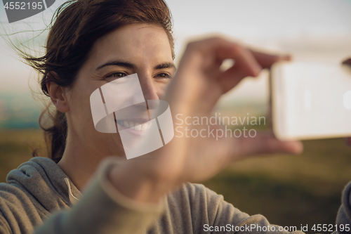 Image of Woman taking a picture