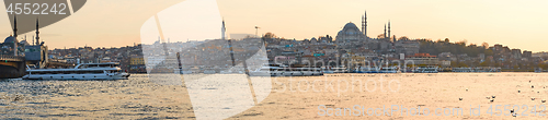 Image of Tourist boat sails on the Golden Horn in Istanbul at sunset, Turkey.