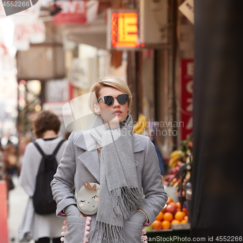 Image of Young blond woman with sunglases on the street