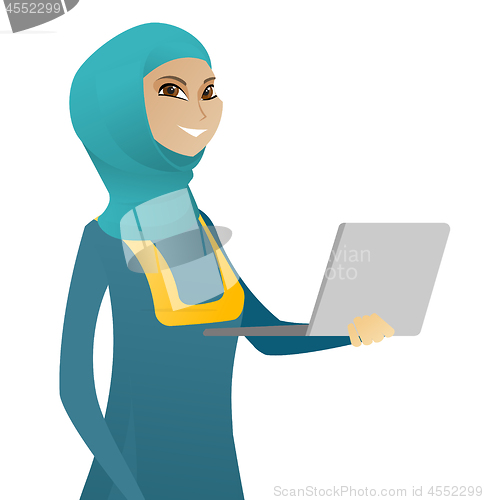 Image of Young muslim business woman using a laptop.
