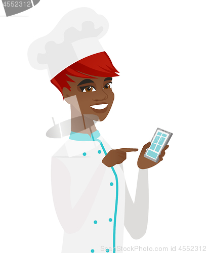 Image of Young african-american chef holding mobile phone.