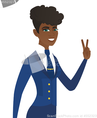 Image of Arican stewardess showing the victory gesture.