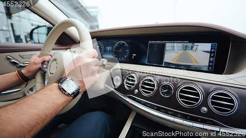 Image of Man sitting and driving in the car.