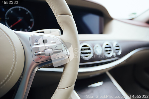 Image of Control buttons on steering wheel. Car interior.