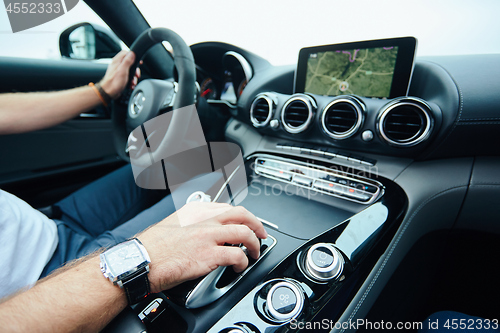 Image of hand on automatic gear shift, Man hand shifting an automatic car