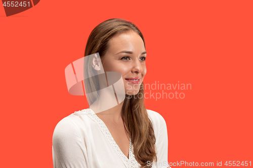 Image of The happy business woman standing and smiling against red background.