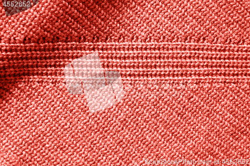 Image of Closeup macro texture of knitted cotton waffle fabric in a color of the year 2019 Living Coral Pantone.