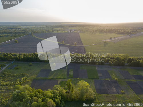 Image of Landscape view over the field and trees against the sky. Photo from the drone