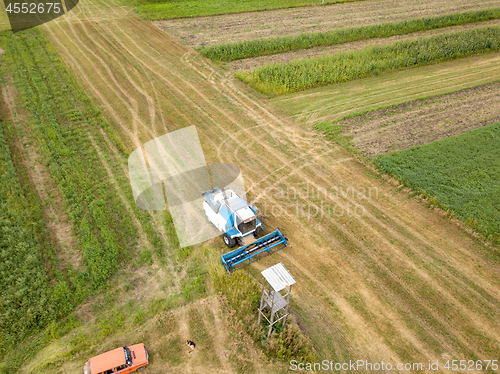 Image of Panoramic aerial view from the drone of the field after harvest. The combine harvester reaps a crop in the field.