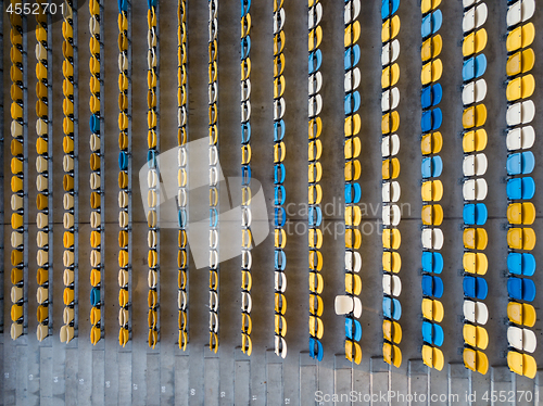 Image of KYIV, UKRAINE - July 19, 2018. Top view of empty blue and yellow seats on a tribunes of NSC Olimpiysky before the soccer game.