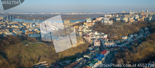 Image of A bird\'s eye view, aerial panoramic view from drone to the Podol district, oldest historical center of Kiev, the Dnieper River and the left bank of Dnieper in the city of Kiev, Ukraine.