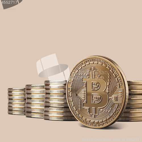 Image of Cryptocurrency physical bitcoin gold coin and stacks of coins on backgound