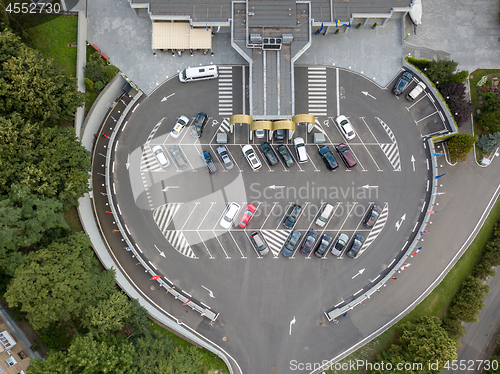 Image of Aerial view from the drone to parking for cars of a round shape with cars on it.