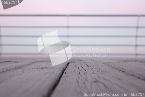 Image of Wooden deck overlooking the sea sunrise with shallow depth of field.