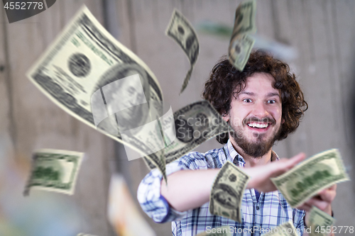 Image of businessman making the rain of money