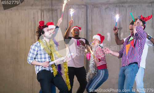 Image of multiethnic group of casual business people dancing with sparkle