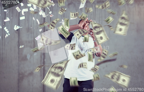 Image of black businessman making the rain of money